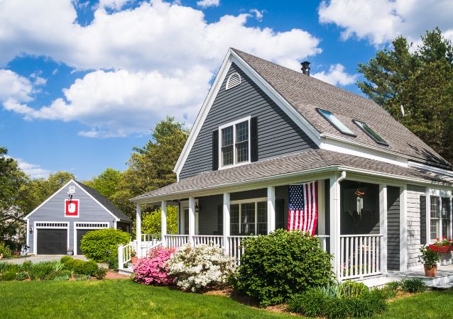 A grey single family Richmond Hill home is pictured with an american flag and a great curb appeal.
